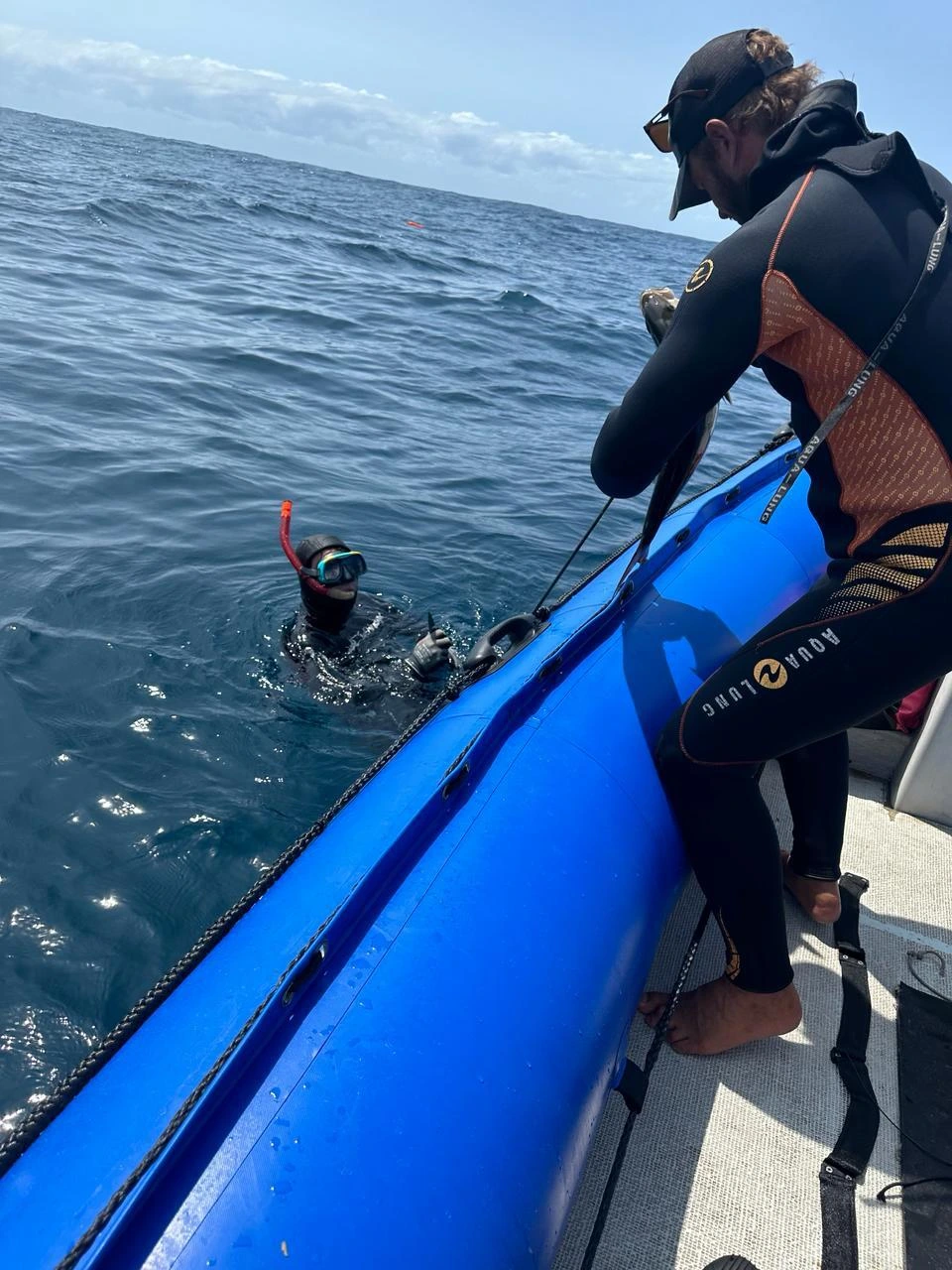 Spearfisher handling caught fish